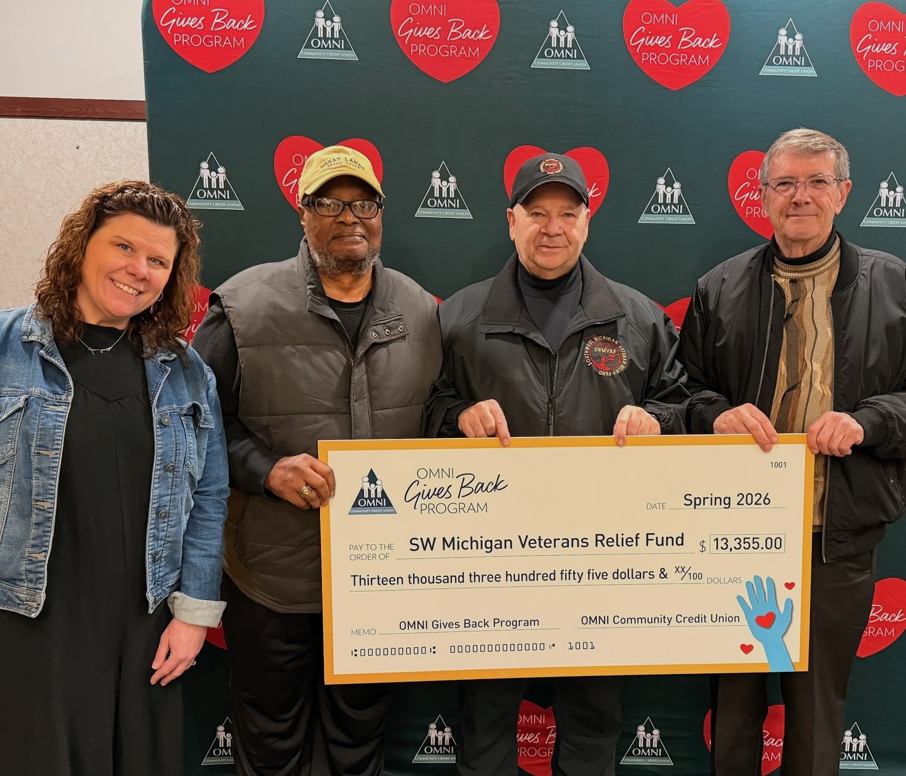 Representatives from OMNI Community Credit Union present a $13,355 donation.