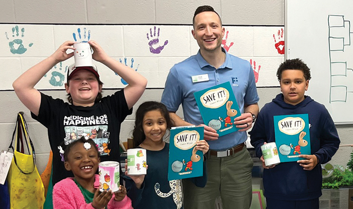 Kids smiling while holding crafts and books