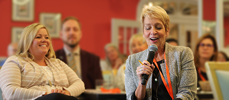 Woman with microphone, smiling